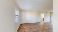 Located at 6440 62nd Ave N in Pinellas Park, Florida, this single-floor, 2-bedroom, 2-bathroom residence offers a practical and comfortable layout. The combined kitchen and living area serves as the heart of the home, featuring durable wood-look flooring, neutral-toned walls, and a textured ceiling throughout. The kitchen is equipped with white cabinetry, a coil-burner electric range, a full-size refrigerator, and a skylight detail above, providing ample natural light. The living area opens directly onto a private balcony through a sliding glass door, extending the living space outdoors. Both bedrooms are carpeted for comfort, with the primary bedroom offering a closet and a window with outdoor views. The second bedroom also features a closet and natural light. Three closets in total provide generous storage throughout the unit. The two bathrooms each include a shower/tub combination, a vanity with storage, and a window for ventilation and natural light — one features a dark-toned vanity with a framed mirror, while the other offers a clean, minimalist design. A dedicated utility room and a connecting hallway complete the functional floor plan, making this a well-organized and efficiently designed residence.