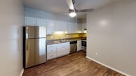 Located at 4302 Plantation Rd NE in Roanoke, Virginia, this single-floor residence offers a practical and comfortable layout throughout. The living area is finished with rich, dark hardwood-style flooring and features a full-length sliding glass door dressed with vertical blinds, allowing abundant natural light to fill the space while providing direct access to the outdoors. The kitchen is well-equipped with white cabinetry, dark countertops, a yellow tile backsplash, and stainless steel appliances including a refrigerator, dishwasher, and range. A ceiling fan with integrated lighting keeps the kitchen area well-ventilated. The bedrooms are carpeted in warm tan tones, each with neutral-painted walls, flush-mount ceiling lighting, and windows fitted with horizontal blinds that offer both light and privacy. The bathroom features a full tub and shower combination with white tile surround and built-in shelving, complemented by chrome fixtures. Throughout the home, clean white baseboards and neutral wall tones create a cohesive, move-in-ready aesthetic. The straightforward single-floor plan ensures easy accessibility and a functional flow between all areas of the home.