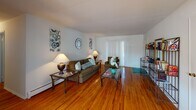 Located at 100 Cedar Ln in Highland Park, NJ, this single-floor, one-bedroom, one-bathroom residence offers a well-organized layout with distinct living, dining, kitchen, and sleeping areas. The living room is a comfortable and inviting space, showcasing warm hardwood floors that extend throughout the home, neutral walls, and a large sliding door that allows natural light to fill the room. A dedicated dining area sits adjacent, featuring a window overlooking greenery and a pendant light fixture overhead, creating an ideal spot for meals. The kitchen is equipped with dark wood cabinetry, a gas cooktop, a wall oven, a refrigerator, and a double sink, providing ample storage and functionality. The bedroom is a peaceful retreat with hardwood flooring, a window framing outdoor views, and generous space for furnishings. The bathroom is clean and practical, offering a tiled tub-shower combination, mosaic tile flooring, and a marble-topped vanity with classic black accent tile detailing. Throughout the residence, the consistent hardwood floors and neutral color palette create a cohesive and functional living environment well-suited for comfortable everyday living in the heart of Highland Park.