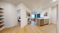 Located at 5900 S Congress Ave in Austin, TX, this 1-bedroom, 1-bathroom residence offers a thoughtfully designed open-concept layout with modern finishes throughout. Light-toned hardwood-style flooring flows continuously across the living, dining, and kitchen areas, creating a cohesive and airy atmosphere. The kitchen is equipped with stainless steel Whirlpool appliances, including a refrigerator, microwave, and range, complemented by light wood cabinetry, white countertops, and a peninsula with bar seating. A dedicated pantry and in-unit laundry add everyday convenience. The combined living and dining area benefits from soaring angled ceilings and large windows that invite abundant natural light, while a sliding glass door opens to a private balcony with open views of the surrounding Austin neighborhood. The bedroom features hardwood-style flooring, a generous window with blinds and curtains, and access to a dedicated closet. The bathroom is finished with wood-tone cabinetry, a large framed mirror, white countertops, and a tub-shower combination with clean tile surround. Clean white walls and contemporary fixtures throughout lend the space a fresh, modern character well-suited to urban Austin living.