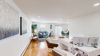 Located at 104 Blue Spring Rd in Princeton, NJ, this single-floor residence offers a well-organized and functional layout with a warm, contemporary aesthetic throughout. Rich hardwood flooring flows seamlessly across the main living areas, anchoring the space with natural warmth and continuity.

The expansive open-plan living and dining area is bathed in natural light from multiple windows fitted with horizontal blinds. The living room provides a comfortable gathering space, while the adjacent dining area benefits from a full-height sliding glass door with vertical blinds that opens to outdoor views of the surrounding greenery. Recessed lighting throughout adds a clean, polished finish.

A dedicated home office area features ample workspace and additional recessed lighting, making it a practical and versatile area for productivity. The bedroom is generously proportioned, offering two large sliding-door closets and windows that invite natural light, creating a serene retreat.

The kitchen is thoughtfully updated with white shaker cabinetry, quartz countertops, a subway tile backsplash, and a full suite of stainless steel appliances, including a gas range, built-in microwave, and refrigerator. Light-toned flooring complements the bright, clean design.

The bathroom includes a tub-shower combination with sliding glass doors and classic tile surround, offering a tidy and functional finish. Overall, the space presents a bright, move-in-ready environment in a desirable Princeton location.