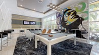 This contemporary single-floor amenity lounge is a visually dynamic space designed for social gathering and recreation. The room makes an immediate impression with soaring ceilings, a striking tray ceiling detail, and a bold, large-scale pop-art mural that dominates one wall, featuring vibrant splashes of blue, yellow, green, and purple. A sleek white pool table anchors the central area, positioned beneath a sculptural cluster chandelier with cylindrical metallic fixtures that cast warm, focused light over the space.

The lounge is furnished with an eclectic mix of retro-modern seating, including curved egg-style chairs in gold and white tones, low-profile tufted leather armchairs, and high bar stools, all arranged across a dramatic dark, marbled-pattern area rug set against polished terrazzo flooring. One accent wall features a bold geometric diamond lattice design in crisp white, adding architectural depth and visual interest.

A dedicated kitchenette/wet bar runs along one side of the space, outfitted with white cabinetry, a stainless steel sink, built-in appliances, reflective tile backsplash, and mounted flat-screen televisions. Floor-to-ceiling windows flood this area with natural light and offer views of lush outdoor palm trees and a pool terrace beyond, creating a seamless indoor-outdoor ambiance throughout the entire space.