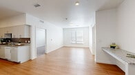 Located at 1510 N Valentia St in Denver, CO, this well-appointed 2-bedroom, 1-bathroom residence offers a thoughtfully designed single-floor layout with a bright, clean aesthetic throughout. The open living area features light wood-style flooring, white walls, and a window that fills the space with natural light, creating a welcoming and airy atmosphere.

The galley-style kitchen is a standout feature, offering granite countertops, crisp white cabinetry with brushed nickel hardware, a white appliance suite including a range, microwave, and dishwasher, and a stainless steel sink. The hardwood-style flooring continues here, tying the space together seamlessly.

Both bedrooms are carpeted for comfort and feature sliding closets for ample storage, as well as windows with blinds that allow natural light while maintaining privacy. The primary bedroom provides a generous footprint with room for a full furniture arrangement.

The bathroom mirrors the kitchen's design language, featuring granite countertops, white cabinetry, a large vanity mirror, and a shower/tub combination. The consistent use of white tones and quality finishes throughout gives this residence a cohesive, modern feel well-suited for comfortable urban living in Denver.