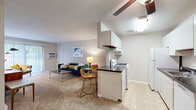 Located at 8712 S 87th Ter in Justice, IL, this single-floor residence offers a practical and comfortable layout designed for everyday living. The open-concept living area flows naturally into the kitchen, creating a connected and functional common space. The living room features soft carpeting, a ceiling fan, and a sliding glass door that fills the room with natural light and provides direct access to an outdoor green area. A wall-mounted air conditioning unit ensures year-round comfort.

The galley-style kitchen is efficiently organized with white cabinetry extending to the ceiling, dark countertops, a gas range, refrigerator, and dishwasher. A peninsula with seating connects the kitchen to the dining and living areas, making it ideal for casual meals and entertaining.

The bedrooms are carpeted and offer a calm, neutral atmosphere. The primary bedroom features a window with outdoor views, providing natural light and a sense of openness. A secondary room offers flexible use as a bedroom or additional living space. Throughout the unit, textured ceilings and neutral wall tones create a clean, cohesive aesthetic.

The bathroom is finished with white tilework surrounding a tub and shower combination, a white vanity with under-sink storage, and a large mirror, delivering a bright and functional space.