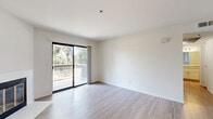 Located at 3364 Honeybrook Way in Ontario, CA, this well-appointed one-bedroom, one-bathroom home offers a thoughtfully designed single-floor layout with a clean, modern aesthetic. Light-toned wood-look flooring flows throughout the space, complementing the bright white walls and creating a cohesive, airy atmosphere.

The open-concept living room and kitchen area serves as the heart of the home. The living room features a stylish fireplace with a classic surround and a sliding glass door that opens onto a private balcony with lush greenery views. A ceiling fan adds comfort, and the pass-through window connects seamlessly to the kitchen. The kitchen is equipped with stainless steel appliances, including a range, microwave, and refrigerator, along with white shaker cabinetry, contemporary countertops, and a skylight that enhances natural illumination.

The bedroom is a comfortable, well-proportioned retreat filled with natural light from a window with blinds and includes a dedicated closet. The full bathroom is finished with white shaker-style cabinetry, brushed nickel hardware, a large vanity mirror, and a tub/shower combination. A dedicated in-unit laundry room with a full-size washer and dryer adds everyday convenience, rounding out this functional and attractive home.