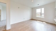 Located at 4800 Iron Gate Dr in Timnath, Colorado, this thoughtfully designed two-bedroom, one-bathroom residence offers a clean, modern aesthetic throughout. The open-concept kitchen and living area serves as the heart of the home, featuring warm wood cabinetry, a large white quartz island with pendant lighting, stainless steel appliances including a French door refrigerator and gas range, and recessed lighting that brightens the space. Light wood-toned flooring flows throughout the main living areas, adding warmth and continuity to the design.

Both bedrooms are comfortably sized, with large windows that invite generous natural light and views of the surrounding neighborhood. The primary bedroom features plush carpeting and a ceiling fan, while the second bedroom also offers carpet flooring and bright window exposure. A dedicated closet provides additional storage.

The full bathroom is well-appointed with warm wood vanity cabinetry, a white quartz countertop, a full tub and shower combination with tile surround, and wood-look flooring that ties together the overall design palette. A private balcony extends the living space outdoors. Clean white walls, modern fixtures, and consistent finishes throughout give this residence a cohesive, contemporary feel.