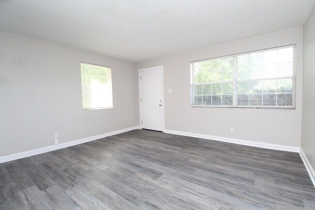 Building Photo - North Pensacola 2BR, 1BA Brick Duplex with Fresh Paint, Wood-Looking Flooring, Fenced Backyard.