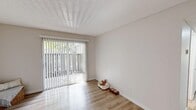 Located at 1300 North L St in Lompoc, CA, this single-floor, 2-bedroom, 2-bathroom residence offers a clean, modern aesthetic throughout. Light wood-style flooring runs continuously across the living spaces, creating a cohesive and bright interior. The living room is a welcoming area anchored by a full sliding glass door fitted with vertical blinds, allowing abundant natural light and direct access to an outdoor patio with greenery views.

The kitchen has been thoughtfully updated with white upper cabinetry, gray lower cabinetry, white countertops, and stainless steel appliances including a gas range, microwave, refrigerator, and dishwasher. A peninsula counter provides additional prep space and a casual dining area. Recessed lighting keeps the kitchen well-illuminated.

Both bedrooms are quiet and airy, featuring light-toned walls, wood-style flooring, and windows that invite natural light. The primary bedroom includes a closet, while the layout benefits from three closets in total throughout the unit. A hallway connects all rooms efficiently.

The bathrooms maintain the home's clean palette with gray vanity cabinetry, white countertops, large mirrors, and shower-tub combinations. Textured ceilings are present in select areas, adding a classic touch to the otherwise contemporary interior.