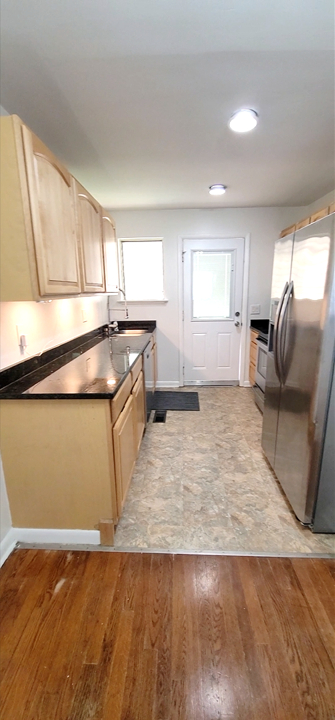 Kitchen with Stainless Steel Appliances and Resilient Flooring - 1123 W Mississippi Ave