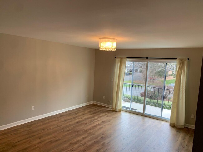 Living room leading out to the balcony. - 7113 Quail Meadow Ln