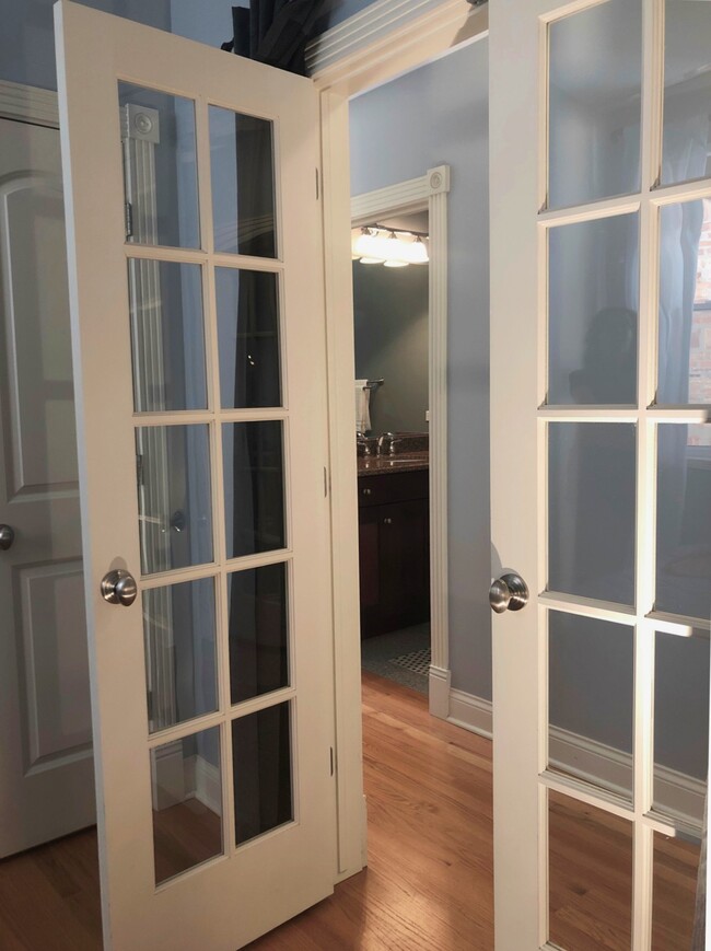 View from inside bedroom. In background is your private bath. Locking French doors have gray curtains to pull across for privacy. I can change it to normal doors if desired. - 5210 N WINTHROP AVE, APT 4