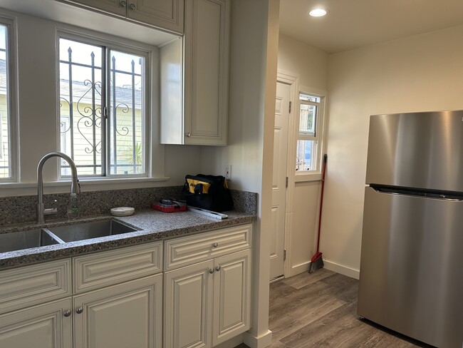 Granite countertop, deep sink, new cabinets, and stainless steel refrigerator with ice maker. - 5027 2nd Ave