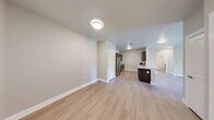Located at 13411 FM812 in Del Valle, TX, this well-designed single-story home offers three bedrooms and two full bathrooms across a comfortable and efficiently laid-out floor plan. Light wood-style flooring flows throughout the entire home, lending a clean, cohesive aesthetic to every room. The open-concept kitchen and living area form the heart of the home. The kitchen is outfitted with dark espresso cabinetry, granite countertops, a subway tile backsplash, and a full suite of stainless steel appliances including a refrigerator, electric range, built-in microwave, and dishwasher. The living room features neutral-toned walls, a ceiling fan, and French doors that open to the outdoors, allowing natural light to fill the space. Each of the three bedrooms is fitted with a ceiling fan, neutral wall tones, and double-door closets, providing functional storage. The primary bedroom offers a generous footprint. The two bathrooms are finished with dark cabinetry, granite-topped vanities, and large mirrors. One bathroom includes a tub-shower combination with classic white subway tile surround, while the other features a glass-enclosed shower. The home presents a clean, modern design with consistent finishes throughout.