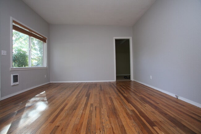Living room from kitchen perspective looking into smaller bedroom/office - 5431 SE Tibbetts St