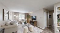 Located at 60 Knoll Ct in Carmel, Indiana, this thoughtfully designed one-bedroom, one-bathroom residence offers an efficient and comfortable single-floor layout. The living room serves as the heart of the home, featuring warm wood-look flooring, neutral walls bathed in natural light from a large window, and an open flow into the dining area — ideal for both relaxing and entertaining. The galley-style kitchen is well-equipped with warm wood cabinetry, light countertops, black appliances including a full-size refrigerator, a double sink, and a skylight that brightens the space. It opens directly to the dining area, enhancing the home's connectivity. The bedroom is a calm retreat, featuring plush carpeting, a wide sliding-door closet, a sun-letting window with blinds, and soft neutral tones throughout. The full bathroom is cleanly finished with a shower-tub combination and wood-look flooring that carries through from the hallway. A dedicated utility room adds practical storage and functional convenience. Throughout the home, a cohesive palette of warm beige tones and wood accents creates an inviting, unified ambiance well-suited for comfortable everyday living in the heart of Carmel.