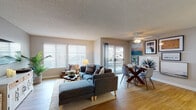 Located at 848 Webber Cir in Ventura, California, this single-story residence offers a thoughtfully designed layout with a bright, open-concept living and dining area at its heart. The living room features warm wood-look flooring, large windows with plantation shutters that invite abundant natural light, and a sliding glass door leading to an outdoor patio. A ceiling fan adds both function and style overhead, while the adjoining dining area accommodates a glass-top table and provides a seamless flow for everyday living and entertaining.

The kitchen is outfitted with crisp white cabinetry, white appliances including a gas range and dishwasher, and generous counter space, complemented by a window that brings in additional natural light.

The primary bedroom is a serene retreat, featuring plush carpeting, a bold patterned accent wall, and a sliding glass door that opens directly to an outdoor space. A second bedroom offers similarly comfortable finishes. Both bathrooms are finished in clean, bright white tones, each featuring a wide vanity with a large mirror, and one includes a shower-tub combination. Throughout the residence, textured ceilings and neutral wall tones create a cohesive, relaxed California coastal ambiance.
