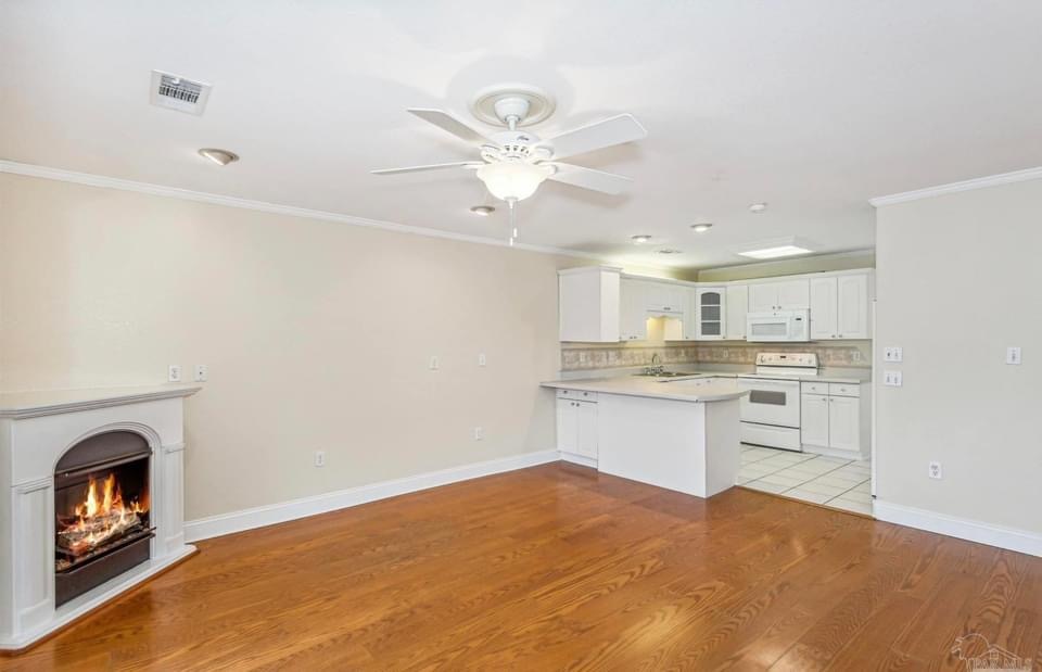 Great room with fireplace and view of the courtyard - 201 Pensacola Beach Rd