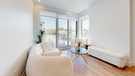Located at 2855 Ch Bates in Montréal, this well-appointed 2-bedroom, 2-bathroom unit offers a thoughtfully designed single-floor layout with a clean, contemporary aesthetic. The living room serves as the heart of the space, featuring floor-to-ceiling windows and a sliding glass door that flood the room with natural light and offer open views of the surrounding neighbourhood. Warm hardwood flooring runs throughout, complementing the bright white walls and recessed lighting.

The primary bedroom is a comfortable retreat with a large window that brings in ample daylight and an outdoor view. It includes a double door closet, providing generous storage. The second bedroom mirrors this bright aesthetic, also featuring a window with an urban view and its own closet space.

Both bathrooms are finished to a high standard. The main bathroom features large-format beige tiles, a soaking tub with a glass-panelled shower surround, and a floating wood-toned vanity with a white countertop and mirrored cabinet. The second bathroom is equally refined, with matching tile work, a floating vanity, and a glass-enclosed shower area.

A welcoming hallway connects the rooms seamlessly, rounding out this modern, light-filled home.