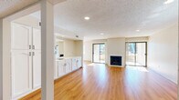 Located at 520 E Murray Canyon Dr in Palm Springs, California, this single-story residence offers 2 bedrooms and 2 bathrooms within a comfortable and well-laid-out floor plan. Warm wood-look flooring runs throughout the main living areas, complementing the neutral wall tones and textured ceilings with recessed lighting. The spacious living room is a standout feature, anchored by a classic fireplace with a white surround and flanked by sliding glass doors on both sides that flood the space with abundant natural light and provide direct access to two private patios. The kitchen is efficiently designed with white cabinetry, light countertops, tile flooring, a full suite of appliances including a range, microwave, dishwasher, and refrigerator, and a separate pantry offering generous storage. A dining area connects seamlessly to the kitchen and living spaces. The generously sized primary bedroom includes a ceiling fan, a built-in cabinet nook, a walk-in closet, and an en-suite bathroom. The second bathroom features a combination soaking tub and shower. A hallway with additional storage and a bathroom with laundry facilities round out the practical layout of this inviting Palm Springs home.