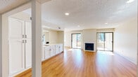 Located at 520 E Murray Canyon Dr in Palm Springs, California, this single-story residence offers 2 bedrooms and 2 bathrooms within a comfortable and well-laid-out floor plan. Warm wood-look flooring runs throughout the main living areas, complementing the neutral wall tones and textured ceilings with recessed lighting. The spacious living room is a standout feature, anchored by a classic fireplace with a white surround and flanked by sliding glass doors on both sides that flood the space with abundant natural light and provide direct access to two private patios. The kitchen is efficiently designed with white cabinetry, light countertops, tile flooring, a full suite of appliances including a range, microwave, dishwasher, and refrigerator, and a separate pantry offering generous storage. A dining area connects seamlessly to the kitchen and living spaces. The generously sized primary bedroom includes a ceiling fan, a built-in cabinet nook, a walk-in closet, and an en-suite bathroom. The second bathroom features a combination soaking tub and shower. A hallway with additional storage and a bathroom with laundry facilities round out the practical layout of this inviting Palm Springs home.