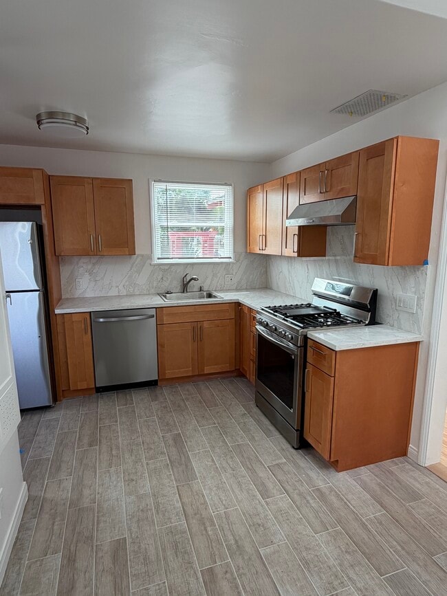 new tiled floor with stone countertop - 701 Indiana Ave