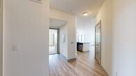 Located in College Station, Texas, this single-floor residence offers a thoughtfully designed layout with 2 bedrooms, 3 bathrooms, and a seamless open-concept living space. Light-toned hardwood-style flooring runs throughout the main living areas, complemented by neutral walls that create a bright, clean aesthetic.

The kitchen serves as a functional centerpiece, featuring rich dark-wood cabinetry, granite countertops, stainless steel appliances, and a large central island with a built-in sink and pendant lighting overhead. The kitchen flows naturally into the living room, which benefits from large windows and a sliding glass door that invite natural light and outdoor views.

Both bedrooms are carpeted for comfort and equipped with ceiling fans. The generously sized primary bedroom connects directly to its own bathroom and a walk-in closet outfitted with wire shelving on multiple walls. The second bedroom is served by its own bathroom as well, featuring a granite-topped vanity with dark cabinetry and hardwood-style flooring. A third bathroom adds further convenience for guests. Each bathroom maintains a consistent, clean design with granite counters and dark wood vanities. Two walk-in closets provide ample storage throughout the residence.