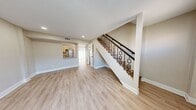 This contemporary two-story residence in Temple Crest, Tampa, offers 730 square feet of thoughtfully designed living space. The home features two bedrooms, including a spacious 140 square foot primary bedroom, and one bathroom. The ground floor spans 380 square feet, while the upper level provides 350 square feet of additional space.

The interior showcases a neutral color palette with light-toned walls and modern wood-look flooring throughout, creating a cohesive and airy ambiance. Large windows in the bedrooms allow ample natural light, enhancing the sense of openness. The updated kitchen boasts sleek light wood cabinetry, stainless steel appliances, and a subway tile backsplash, perfect for culinary enthusiasts.

The bathroom features a modern aesthetic with large format tiles, a white bathtub, and contrasting dark fixtures. Built-in closets in the bedrooms offer practical storage solutions. The open-concept living area seamlessly connects to the kitchen, ideal for entertaining or relaxed daily living. A staircase leads to the upper floor, efficiently utilizing the vertical space in this compact yet functional home.