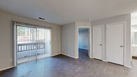 Located at 2208 Yager Creek Dr in Charlotte, NC, this efficiently designed one-bedroom, one-bathroom residence makes excellent use of its single-floor layout. The living room serves as the heart of the home, featuring wood-style flooring, neutral gray walls, and a large sliding glass door dressed with vertical blinds that invites natural light and provides access to an outdoor area. A dedicated front entry door adds a sense of arrival to the space.

The kitchen is thoughtfully outfitted with white shaker-style cabinetry, light quartz countertops, and a full suite of stainless steel appliances including a refrigerator, electric range, over-the-range microwave, and dishwasher. Light wood-style flooring complements the clean, modern aesthetic.

The bedroom is a comfortable, well-proportioned retreat with matching wood-style flooring, soft neutral tones, and a window that brings in natural light and outdoor views. A dedicated closet provides convenient storage.

The bathroom includes a full tub-shower combination with chrome fixtures. A standout feature of this residence is the in-unit laundry room, equipped with a full-size washer and dryer and wire shelving above for additional storage — a practical and valued amenity. The space combines functional design with clean finishes throughout.