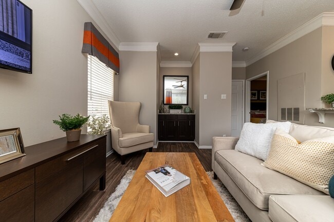 Spacious living room with hardwood-style flooring - The Indigo at Grissom