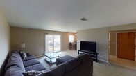 Located at 1901 S Goyer Rd in Kokomo, Indiana, this single-floor residence offers a practical and comfortable layout designed for everyday living. The open living room is generously sized, featuring neutral-toned carpet, warm wall colors, and a sliding glass door that fills the space with natural light and provides access to the outdoors. The room flows naturally toward a dedicated dining nook, where a ceiling fan with light fixture and a window enhance the bright, airy atmosphere adjacent to the kitchen. The kitchen is equipped with white cabinetry, laminate countertops, a range, dishwasher, and refrigerator, all set atop easy-to-maintain tile flooring. The bedrooms are carpeted and well-proportioned, each featuring windows that bring in natural light. The primary bedroom includes a spacious reach-in closet with built-in shelving and rod, while the secondary bedroom offers ample room and dresser storage. The full bathroom is outfitted with a tub-shower combination, toilet, and vanity. Throughout the home, neutral wall tones and consistent finishes create a cohesive and functional living environment suited for a range of occupants.