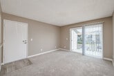 Located at 1767 Oro Vista Road in San Diego, CA, this single-story 2-bedroom, 2-bathroom home offers a well-organized layout designed for comfortable everyday living. The living room features plush carpeting, warm neutral-toned walls, a textured ceiling, and a sliding glass door that opens to a private patio, allowing natural light to fill the space and providing outdoor views of the surrounding community. Adjacent to the living area, the dining room flows naturally into the galley-style kitchen, which is equipped with stainless steel appliances, granite-style countertops, white cabinetry, and light wood-look flooring that adds a clean, modern touch. Both bedrooms are carpeted and feature vertical blinds, neutral walls, and windows that bring in natural light. The spacious primary bedroom includes access to three closets total throughout the unit, offering generous storage. The two bathrooms are finished with white cabinetry, granite-style countertops, and light wood-look flooring, maintaining a consistent, clean aesthetic. A ceiling fan in the dining area adds to the home's practical features. The hallway connects all areas of the home efficiently, completing a cohesive and functional floor plan suited for San Diego living.
