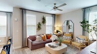 Located along N Loop 1604 E in San Antonio, TX, this thoughtfully designed 2-bedroom, 2-bathroom residence offers a comfortable and functional layout across a single floor. The inviting living room is bathed in natural light from multiple windows dressed with blinds and soft draping curtains, and is topped with a ceiling fan. Wood-look flooring runs throughout the main living areas, lending warmth and a cohesive aesthetic. The primary bedroom features plush carpeting, a ceiling fan, and direct access to its own private bathroom, which is appointed with granite-look countertops, gray cabinetry, and wood-look flooring. A dedicated walk-in closet connects seamlessly to the en-suite bath. The second bedroom is equally well-sized, with carpet flooring, a large window offering natural light, and its own nearby full bathroom complete with a tub-shower combo, granite-look vanity, and coordinating gray cabinetry. Three closets throughout the home provide ample storage, complemented by a dedicated laundry area and a connecting hallway. Carpeted stairs are visible in the space, adding a layered architectural element. The neutral color palette and consistent finishes create a cohesive, modern ambiance throughout this San Antonio residence.