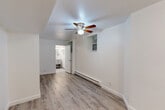 Located in Chicago's Edgewater neighborhood at 5726 N Winthrop Ave, this efficiently designed studio presents a clean, modern aesthetic throughout its single-floor layout. The open main area seamlessly integrates the living, dining, and kitchen functions, finished with light wood-tone laminate flooring, crisp white walls, and a ceiling fan with integrated lighting. A baseboard heating system and a window provide comfort and natural light to the living space. The kitchen is thoughtfully appointed with gray shaker-style cabinetry, a white subway tile backsplash, a stainless steel refrigerator, an electric range, and a single-basin sink — offering full cooking functionality in a compact footprint. Storage is well-addressed with a large double-door closet complemented by an adjacent built-in open shelving niche, keeping the space organized and clutter-free. The bathroom features neutral large-format tile flooring, a gray vanity with open lower shelving, a white countertop, a mirrored medicine cabinet, and strip vanity lighting, creating a clean and functional space. The consistent neutral palette and modern finishes throughout give this studio a cohesive, move-in-ready appeal suited for urban living.