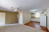 Located at 1416 Delplaza Dr in Baton Rouge, Louisiana, this single-story, 3-bedroom, 1-bathroom home offers a practical and functional layout. The open living and dining area is finished with wall-to-wall carpet and features a ceiling fan with light fixture, neutral beige walls, and a textured ceiling. This space flows directly into the kitchen, which is finished with wood-look flooring and outfitted with white cabinetry, light wood laminate countertops, a double-basin sink, a dishwasher, a range with coil burners, and a full-size refrigerator. A window over the sink brings in natural light. The three bedrooms are carpeted and each features a ceiling fan. Two of the bedrooms include windows with blinds for natural light, while the primary bedroom includes a dedicated closet with a hanging rod. With four closets total throughout the home, storage is well distributed. A hallway connects the bedrooms to the shared full bathroom, which includes a tub-shower combination. The textured ceilings appear throughout the home, maintaining a consistent aesthetic. The compact, efficient footprint makes this home a straightforward and comfortable single-floor living option.