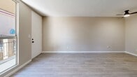 Located at 1101 Dumont Blvd in Las Vegas, NV, this single-story 1-bedroom, 1-bathroom unit offers a practical and well-organized layout. Throughout the home, light wood-look flooring and neutral beige tones create a clean, cohesive aesthetic, complemented by white baseboards and textured ceilings.

The combined living and dining area provides an open, versatile space anchored by a ceiling fan. Large enough to accommodate both lounging and dining arrangements, the room flows naturally toward the entry and into the rest of the unit. A window in the bedroom frames a view of palm trees, adding a distinctly Las Vegas character and bringing in natural light.

The galley-style kitchen is efficiently designed with white cabinetry, granite-look countertops, a double-basin sink, and white appliances, including a range and refrigerator. Ample upper and lower cabinet storage makes the most of the space.

The bedroom is a comfortable, well-proportioned room featuring a double-door closet for convenient storage. An additional closet is accessible from the hallway area near the bathroom, providing further storage options. The bathroom includes a vanity with a white countertop and connects to the hallway, offering easy access from the main living areas. A thermostat is also conveniently positioned in the hallway for climate control throughout the unit.