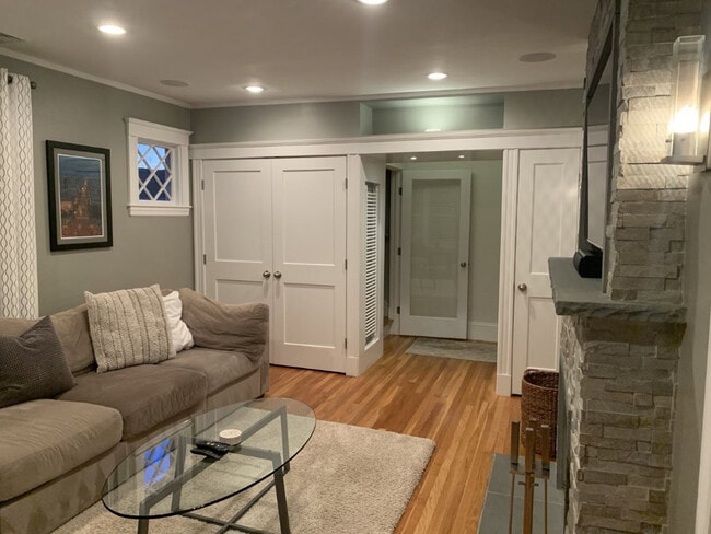 Living room, depicting coat closet (left) & additional storage, right(incl. hidden AV equipment) - 305 Webster St