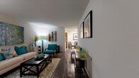 This efficiently designed one-bedroom, one-bathroom residence offers a thoughtful layout that maximizes comfort and functionality throughout its single floor. The combined living and dining area serves as the heart of the home, featuring rich dark hardwood-style flooring, neutral white walls, and ample room for both relaxing and entertaining. A large window allows natural light to fill the living space, creating a bright and welcoming ambiance.

The kitchen is galley-style, outfitted with warm wood cabinetry, light stone-finish countertops, and full-size white appliances including a refrigerator, stove, and dishwasher. Light wood-look flooring ties the space together with a clean, practical aesthetic.

The bedroom is a comfortable retreat finished with plush carpeting, a ceiling fan with overhead lighting, and windows dressed with sheer curtains that invite soft natural light. Two closets provide generous storage throughout the unit.

The bathroom is finished with wood-tone cabinetry, a stone-finish vanity countertop, an overhead storage cabinet, and wood-look flooring, lending a cohesive and tidy feel. A hallway connects the rooms, contributing to the home's logical and easy-to-navigate flow. Overall, the space presents a warm, contemporary character well-suited for comfortable everyday living.