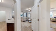 Located at 100 Dalton Ln in Charlottesville, VA, this well-appointed single-floor residence offers three bedrooms, two bathrooms, a dedicated office, and a utility room within a thoughtfully designed layout. The open-concept kitchen and living area serves as the heart of the home, featuring rich dark cabinetry, stainless steel appliances, granite countertops, a large kitchen island with bar seating, and pendant lighting. Wood-style flooring flows throughout the main living areas, complemented by a ceiling fan and multiple windows that invite natural light. The living room is bright and welcoming, with arched column details framing the entryway. The primary bedroom is a comfortable retreat with plush carpeting, a ceiling fan, and ample natural light. Additional bedrooms are similarly finished with carpet and windows. The dedicated office space features large windows overlooking the surrounding neighborhood, ideal for working from home. The bathrooms are finished with granite-top vanities, dark wood cabinetry, and tub-shower combinations with wood-look tile flooring. A utility room with in-unit laundry adds everyday convenience. Crown molding and clean white walls throughout contribute to a polished, cohesive aesthetic.