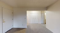 Located at 4201 W Dickman Rd in Springfield, Michigan, this single-floor unit offers a clean, functional layout designed for comfortable everyday living. The living area is carpeted and filled with natural light from a large sliding glass door that opens to a view of the surrounding green landscape — a standout feature that brings the outdoors in. A wall-mounted air conditioning unit and baseboard heating throughout ensure year-round comfort.

The galley-style kitchen is efficiently designed with white cabinetry, granite-look countertops, a gas range, a stainless steel refrigerator, and a double-basin sink — providing ample workspace and storage for home cooking. Light wood-look flooring runs through the kitchen, adding a warm, cohesive feel.

The bedroom offers a comfortable, carpeted retreat with a large double-door louvered closet providing generous storage. A window with blinds frames views of the open green surroundings, filling the room with natural light. The full bathroom is neatly appointed with a vanity featuring a granite-look countertop, white cabinetry, a toilet, and a tub-shower combination, all set on light wood-look flooring. The entryway provides a welcoming transition into the unit with a mix of carpet and hard-surface flooring. Overall, the space presents a bright, neutral palette throughout.