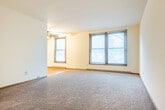Located at 6313 Lakeview Blvd in Middleton, WI, this single-story, 3-bedroom, 1-bathroom home offers a practical and comfortable layout. The living room is generously sized, featuring plush carpeting, two windows that invite natural light and outdoor views, and a ceiling fan for year-round comfort. It connects openly to the kitchen area, which is finished with light tile flooring, warm oak cabinetry, dark granite-style countertops, and black appliances including a full-size refrigerator. The three bedrooms are finished with warm hardwood floors and ceiling fans. Each bedroom features closet space, with the primary bedroom offering a double sliding mirrored closet, and one bedroom featuring dual side-by-side closets for ample storage. Windows in the bedrooms provide natural light and views of the surrounding greenery. The full bathroom includes a single-sink vanity with oak cabinetry, a tiled tub-shower combo, and tile flooring. A hallway connects the bedrooms and bathroom efficiently. With three dedicated closets throughout, the home provides solid storage capacity. The consistent hardwood flooring across the bedrooms and dining area, combined with neutral wall tones, gives the space a cohesive and inviting feel throughout.