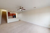 Located at Railroad Plaza in Bay Shore, NY, this multi-level unit offers 2 bedrooms, 2 bathrooms, and a thoughtfully organized layout spread across three floors. The ground level provides direct access to an attached private garage with an automatic opener, offering secure and convenient parking. An entrance foyer leads to the carpeted staircase connecting each level.

The main living floor hosts an open-concept dining room, kitchen, and living room. The kitchen is appointed with rich cherry wood cabinetry, granite countertops, a stainless steel double sink, recessed lighting, and a breakfast bar peninsula. A ceiling fan with light fixture adds comfort to the expansive carpeted living and dining area, which benefits from a clean, neutral color palette throughout.

The upper floor is home to the two bedrooms, including a generously sized primary bedroom featuring crown molding, a ceiling fan, and a large window that invites natural light. The second bedroom also offers carpeted flooring, a closet, and a window with outdoor views. Two full bathrooms—each with a tub-shower combination and white tile surround—serve the residence. Additional features include multiple closets, hallways, a dedicated laundry area, and convenient staircase access between all three levels. A shared parking lot is accessible just outside.