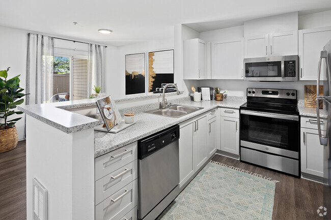 Upgraded kitchens feature new countertops, stainless steel appliances and shaker-style cabinets - Benson Downs