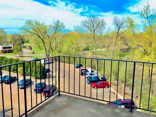 SELECT UNITS: Balcony with creek & parking lot view - Creek Point Apartments