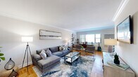 Located at 44 Hill St, Unit 3F in Morristown, NJ, this well-appointed two-bedroom, two-bathroom residence offers a thoughtfully designed single-floor layout. Throughout the home, warm parquet hardwood flooring adds a classic architectural touch that ties each room together cohesively.

The open-concept living and dining area serves as the heart of the home, featuring elegant crown molding, generous natural light from large windows, and a seamlessly connected flow between spaces. The dining area is highlighted by a bold blue accent wall, adding a vibrant focal point. The living room offers ample room for comfortable furnishings and relaxed entertaining.

The galley-style kitchen is sleekly updated with modern two-tone cabinetry, quartz countertops, stainless steel appliances including a refrigerator, gas range, and microwave, and a skylight that brings in additional natural light.

Both bedrooms are generously proportioned, with the primary bedroom offering notable square footage, parquet flooring, and a ceiling fan. The second bedroom is equally comfortable with similar finishes. The two bathrooms are well-appointed, with one featuring hexagonal tile flooring, white wall tiles accented by a mosaic border, and a glass-enclosed shower with tub combination.
