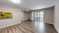 Located at 329 Boulder Dr in Newport News, Virginia, this single-floor, 2-bedroom, 2-bathroom residence offers a practical and well-appointed layout. The living room is a welcoming, open space finished with wood-style plank flooring and neutral-toned walls that create a bright, clean atmosphere. A large sliding glass door leads to a private balcony, framing views of surrounding greenery and allowing natural light to fill the room. An open pass-through connects the living area to the kitchen, enhancing the flow of the space. Both bedrooms are comfortably sized and finished with plush carpeting, large windows that invite natural light, and generous closet space with bi-fold doors. The primary bedroom provides a spacious retreat with ample room for furnishings. The two bathrooms are finished with wood-style flooring, white tub-and-shower combinations equipped with brushed nickel grab bars, and vanities topped with granite-style countertops, lending a touch of refinement. Throughout the residence, consistent neutral tones, clean white trim, and modern finishes contribute to a cohesive and move-in-ready aesthetic. The efficient, thoughtfully organized floor plan makes excellent use of the available space.