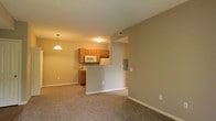 Located at 351 Peat Moss Dr in Columbus, Ohio, this single-floor residence offers a practical and well-organized layout suited for comfortable living. The open-concept design connects the living area and kitchen, creating a cohesive and functional space. The living area features neutral-toned carpeting and light-colored walls that contribute to a bright, welcoming atmosphere. A peninsula-style breakfast bar separates the kitchen from the living space while maintaining an open sightline throughout. The kitchen is equipped with oak-toned cabinetry, a built-in microwave, and white appliances, including a refrigerator and stove, offering ample storage and workspace. A pendant light fixture above the breakfast bar area adds a subtle decorative touch and enhances task lighting. The utility panel is conveniently accessible within the unit. Neutral wall tones throughout the space provide a clean, move-in-ready aesthetic that accommodates a variety of interior styles. The single-floor plan ensures easy accessibility and efficient use of space, making this residence a straightforward and functional option in the Columbus, OH area.