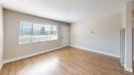 Located at 1865 Lacassie Ave in Walnut Creek, CA, this 2-bedroom, 1-bathroom single-floor unit offers a well-organized layout across a comfortable footprint. The living and dining area greets you with warm hardwood-style flooring, neutral-toned walls, a textured ceiling, and a large window fitted with blinds that fills the space with natural light. The front entry door opens directly into this bright, open area, creating an inviting atmosphere.

The kitchen is well-appointed with white shaker-style cabinetry, ample counter space, stainless steel appliances including a gas range, and hardwood-style flooring that continues from the main living area. A window above the counter provides additional natural light and ventilation.

Both bedrooms feature plush wall-to-wall carpeting and ceiling fans with integrated lighting. The primary bedroom includes a built-in closet with sliding doors, while additional closet storage is available throughout the unit. One bedroom also offers convenient access to the in-unit laundry area.

The full bathroom is clean and functional, featuring a bathtub with shower, a dark-cabinetry vanity with a white countertop, hardwood-style flooring, and a window for natural light. A hallway connects all rooms, contributing to an efficient and practical floor plan throughout this Walnut Creek residence.