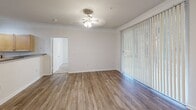 This well-designed apartment in Raleigh, NC offers 990 square feet of living space on a single floor. The layout includes two bedrooms, two full bathrooms, a combined kitchen and living area, two closets, and a dedicated laundry space. The primary bedroom is generously sized at 160 square feet, providing ample room for rest and relaxation.

The living area features plush carpeting and a ceiling fan, while the adjacent space boasts sleek wood-look flooring and vertical blinds, allowing for plenty of natural light. The kitchen is equipped with modern stainless steel appliances, light wood cabinetry, and granite countertops, creating a functional and aesthetically pleasing cooking environment.

Both bathrooms are well-appointed, with one featuring a large bathtub and shower combination. The in-unit laundry room comes complete with a washer and dryer, adding convenience to daily life. Ample storage is provided through built-in closets with wire shelving systems.

Throughout the apartment, neutral-toned walls and ceilings create a bright, open atmosphere, while the mixture of carpet and wood-look flooring adds warmth and easy maintenance. Ceiling fans in multiple rooms ensure comfort year-round. This apartment offers a perfect blend of modern amenities and practical design, ideal for those seeking a comfortable urban living space in Raleigh.