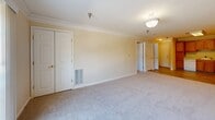 Located at 2195 Mountain View Rd in Stafford, Virginia, this one-bedroom, one-bathroom residence offers a thoughtfully designed single-floor layout. The open-concept living, dining, and kitchen area forms the heart of the home, bathed in natural light from a sliding glass door that leads to a private balcony. Elegant crown molding accents the living and dining space, while neutral-toned walls and plush wall-to-wall carpeting create a warm, inviting atmosphere throughout.

The kitchen is well-appointed with warm oak cabinetry, ample counter space, and a full suite of white appliances including a refrigerator, electric range, microwave, and dishwasher. Light wood-style flooring grounds the space and transitions seamlessly into the carpeted living area.

The spacious bedroom features crown molding, soft carpeting, and a large window that fills the room with natural light. Three closets throughout the unit provide generous storage. The full bathroom is finished with wood-look tile flooring, an oak vanity with a white countertop, and a tub/shower combination. An in-unit laundry area adds everyday convenience, completing this well-organized and comfortable Stafford residence.