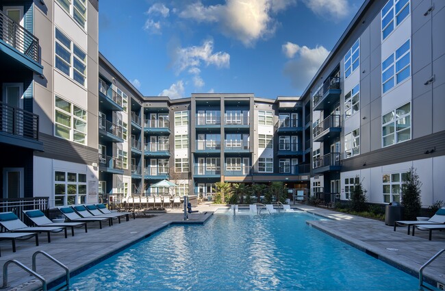 Pool Deck Featuring Lounge Chairs, Courtyard Views, and Walk-Up Access - NoDa Flats